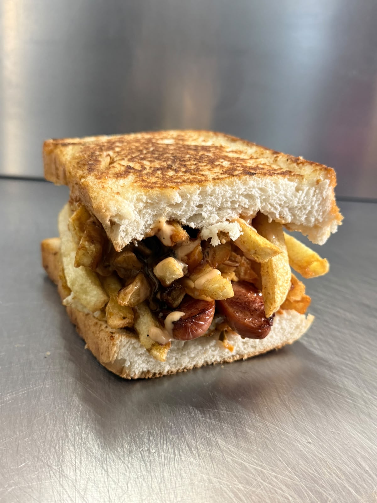 Flame-grilled kota stacked with beef, cheese and chips